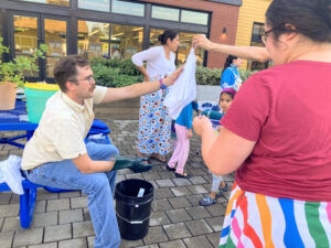 Teens learn to make tie-dye T-shirts at a library STEAM program