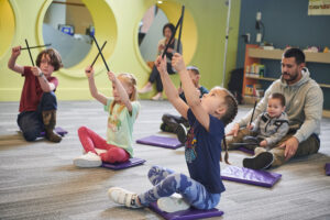 White and Latino children and parents enjoying storytime together at the library